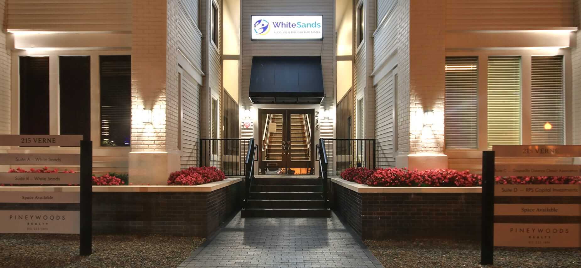 Night view of main entrance with White Sands sign