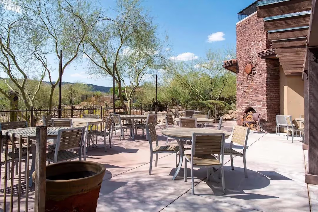Tables and chairs on patio with desert views