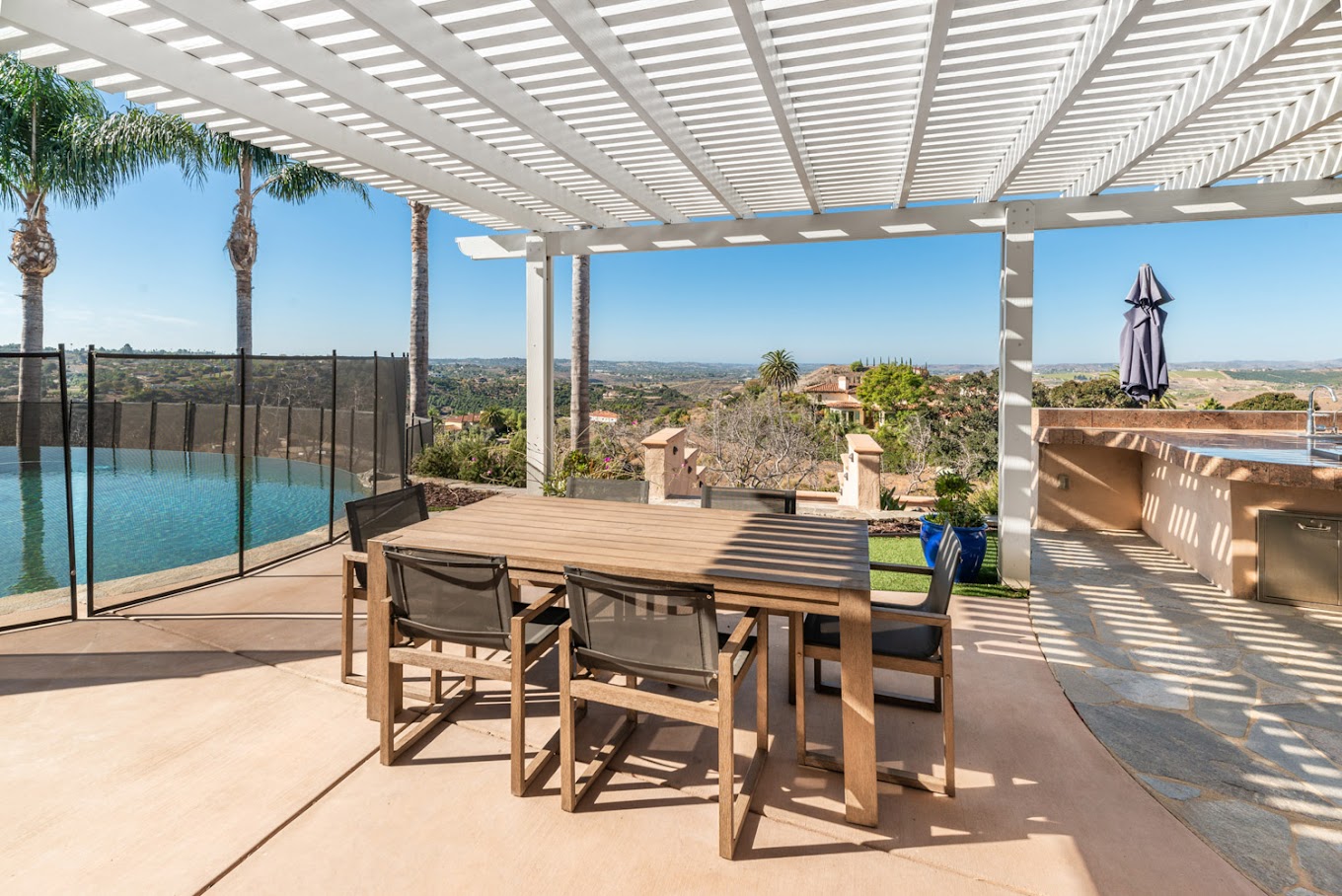 shaded outdoor seating area nest to a barbaque space.