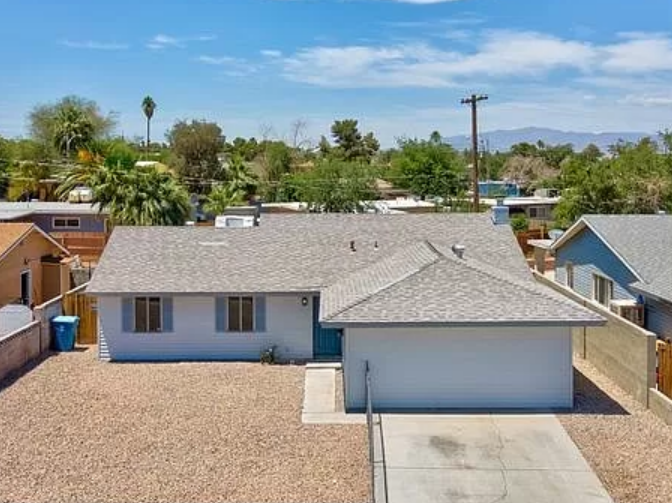 One-story house with gravel yard and two-car driveway