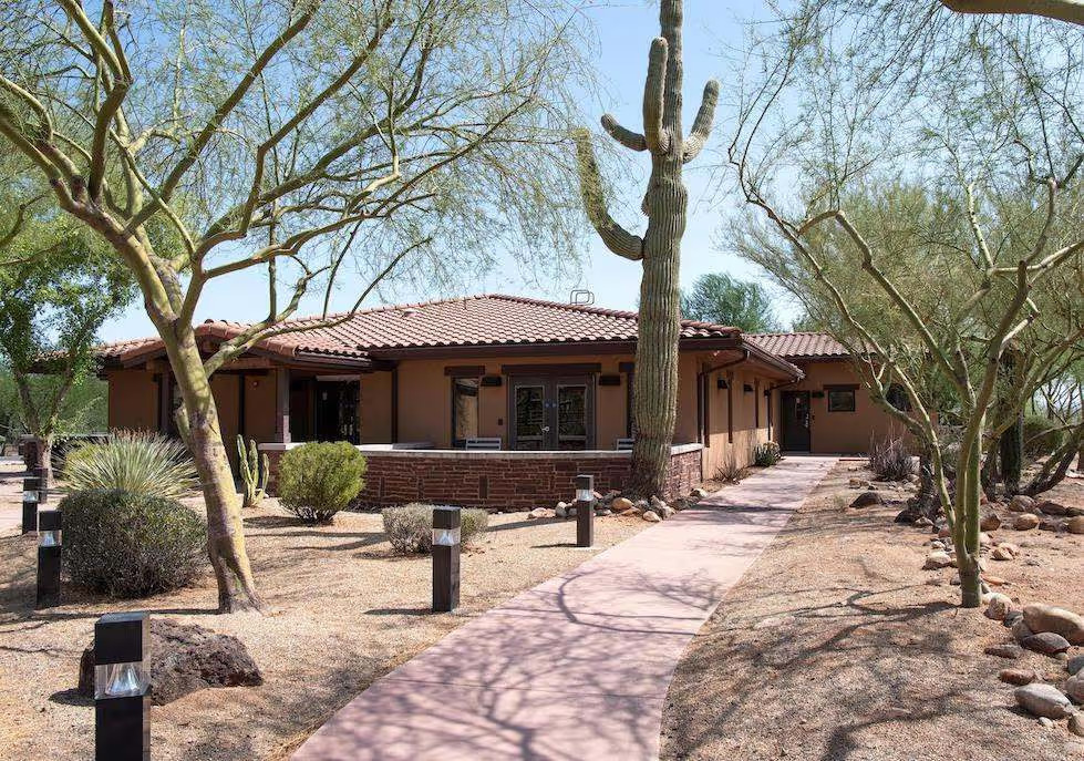 Walkway leading to entrance with desert plants and cacti