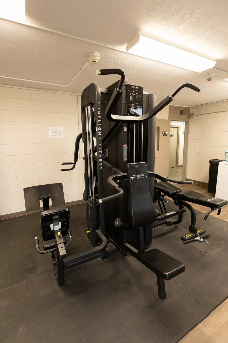 Fitness room with multi-station exercise equipment inside addiction treatment facility