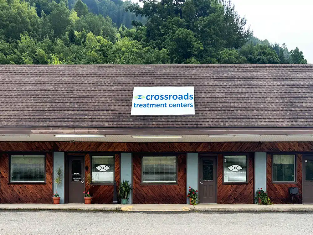 Single-story clinic building with Crossroads sign and trees