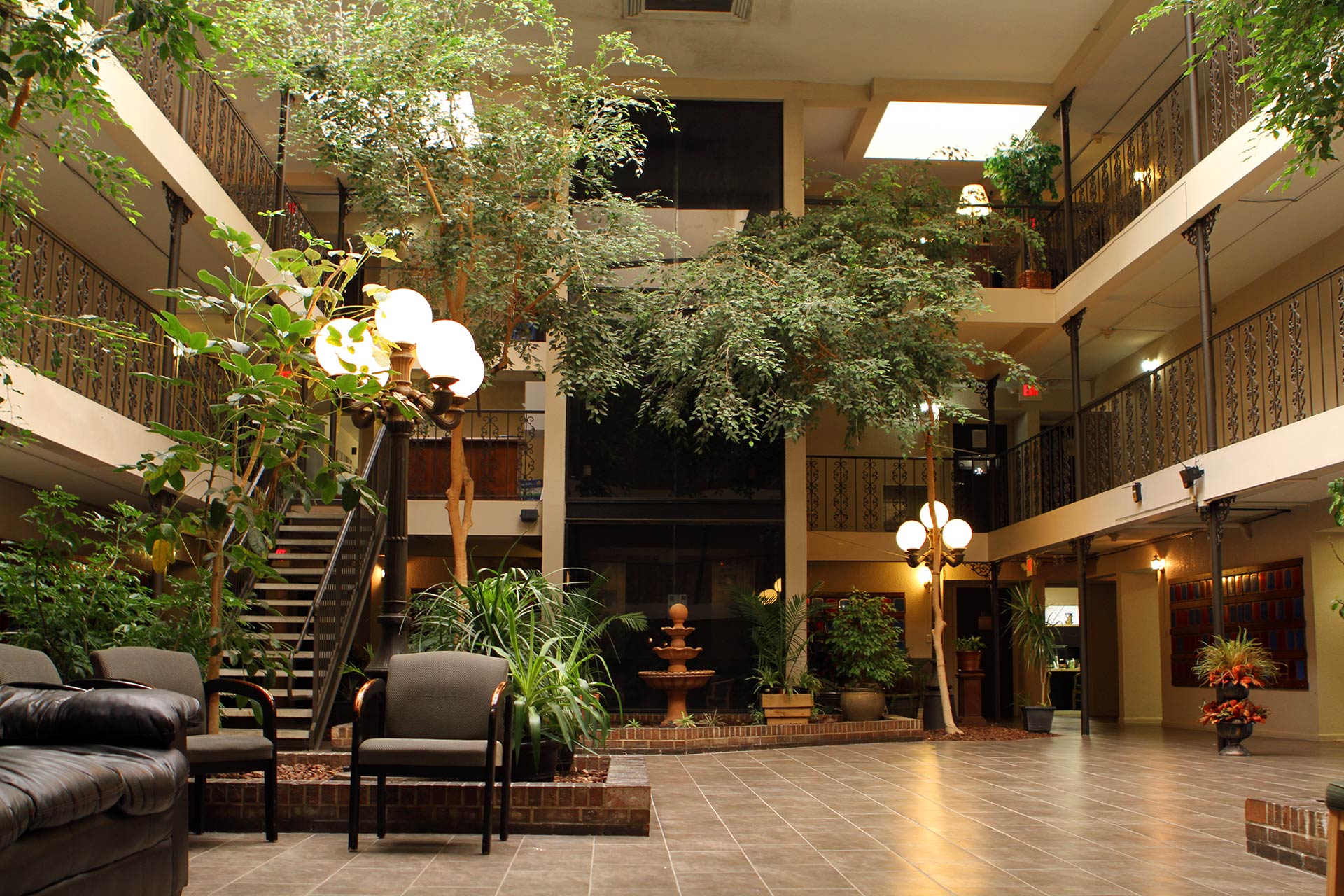 Indoor garden atrium with fountain and chairs