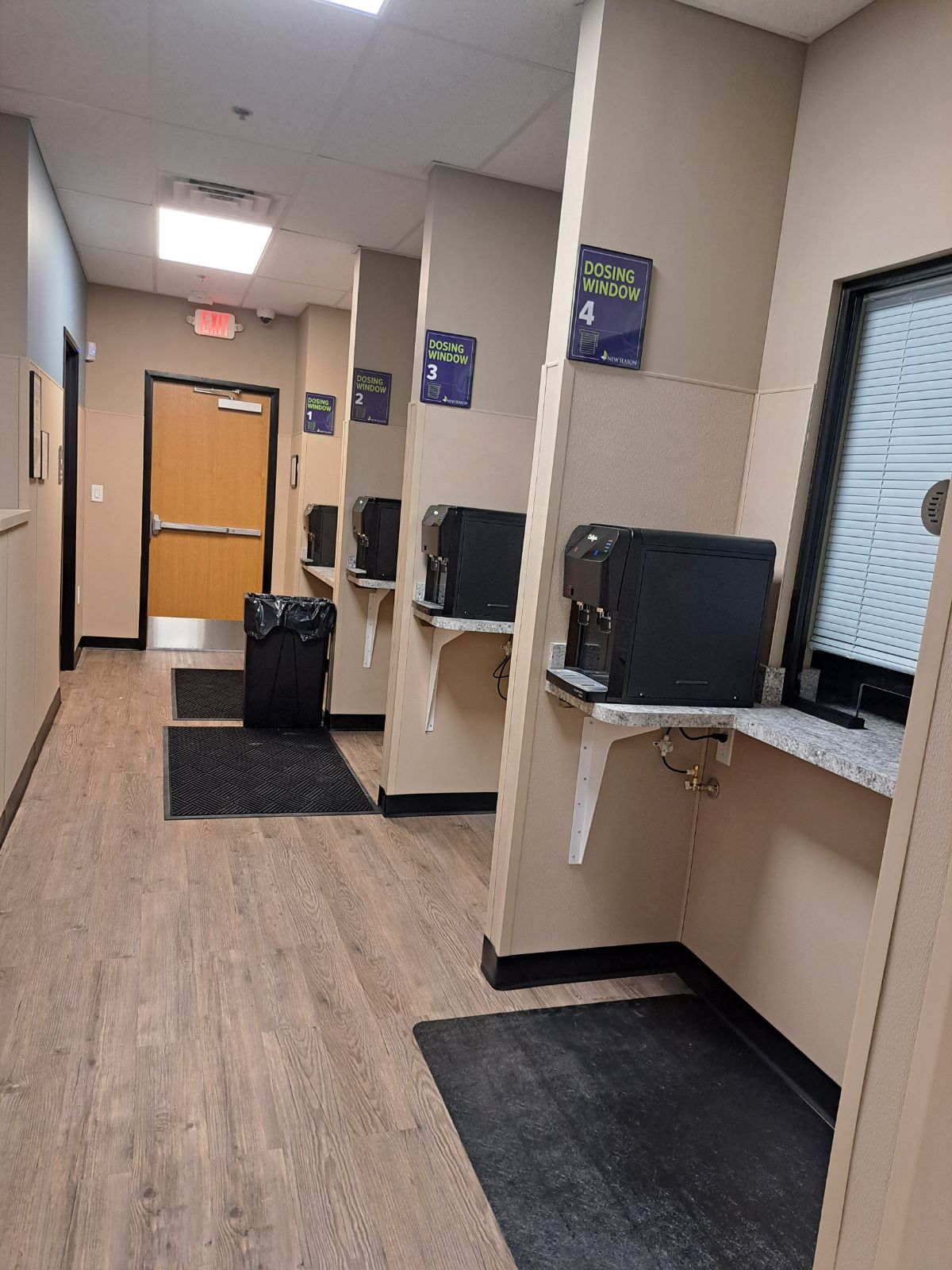 Individual medication dosing windows along clinic hallway.