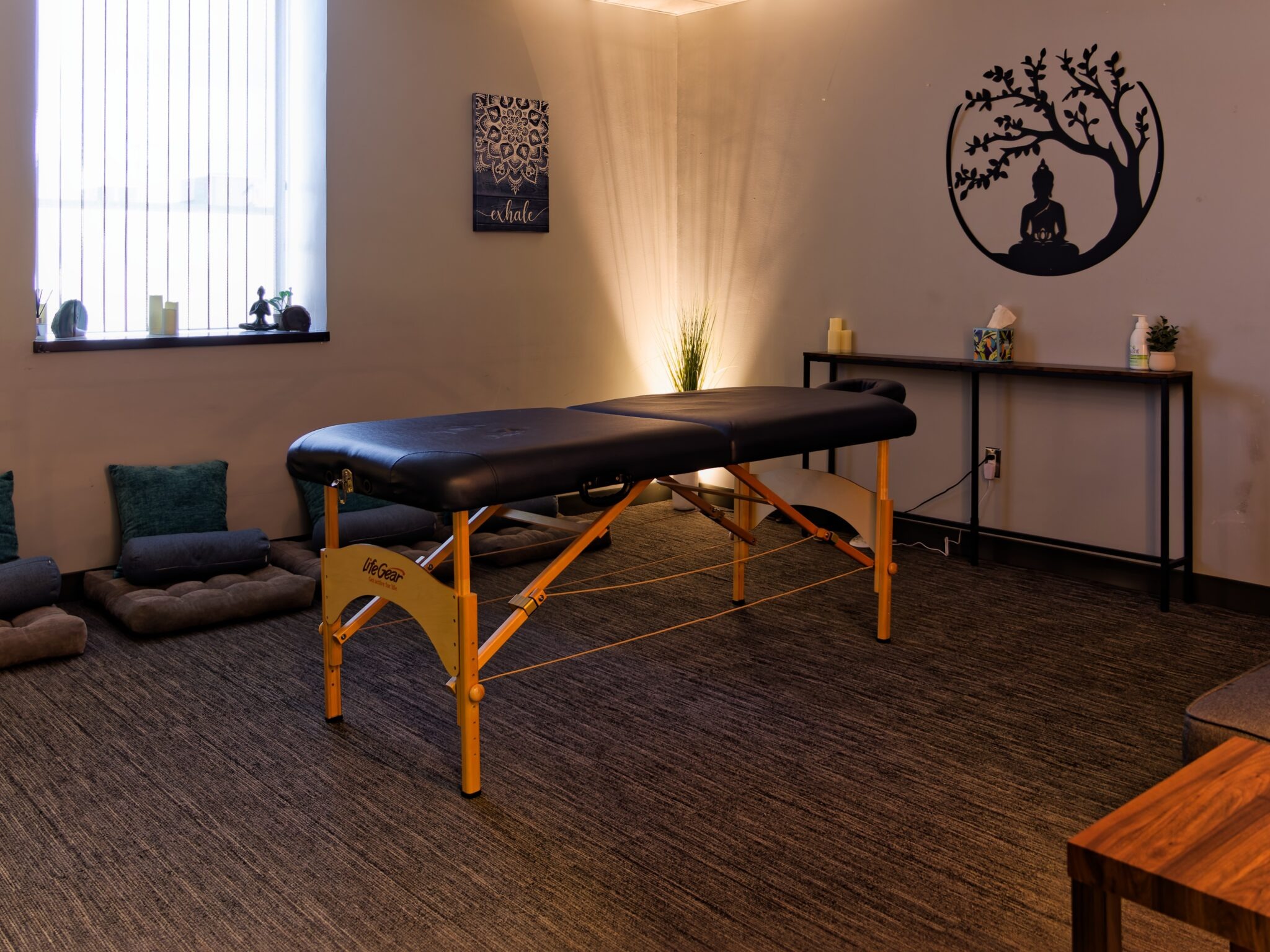 Calming wellness room with massage table and soft lighting.
