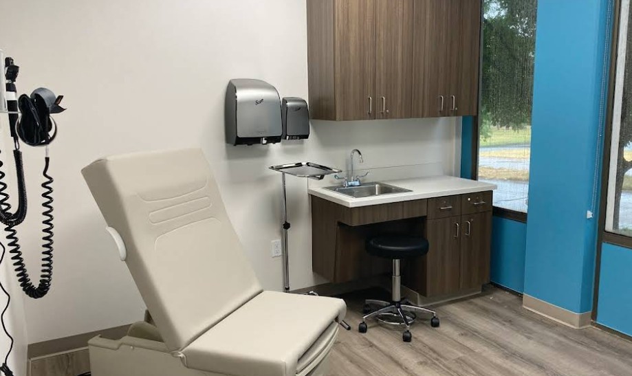 Medical exam room with exam table and sink