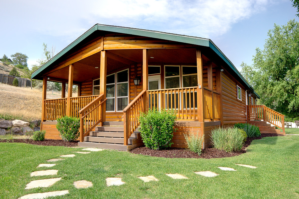 Log cabin-style residence with covered porch and stone path
