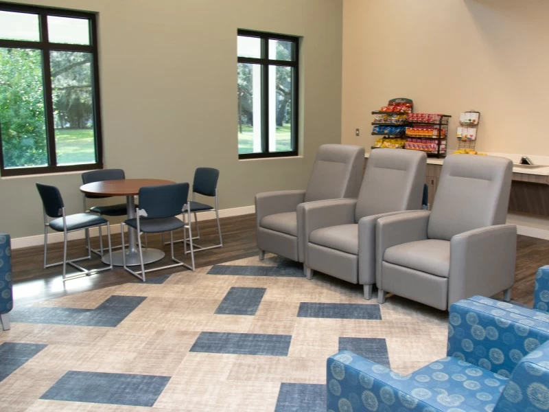 Lounge with chairs, tables, and snack station