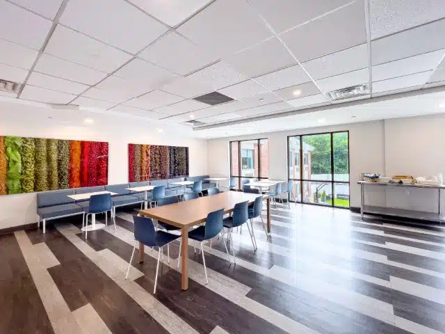 A bright dining room with colorful wall art.