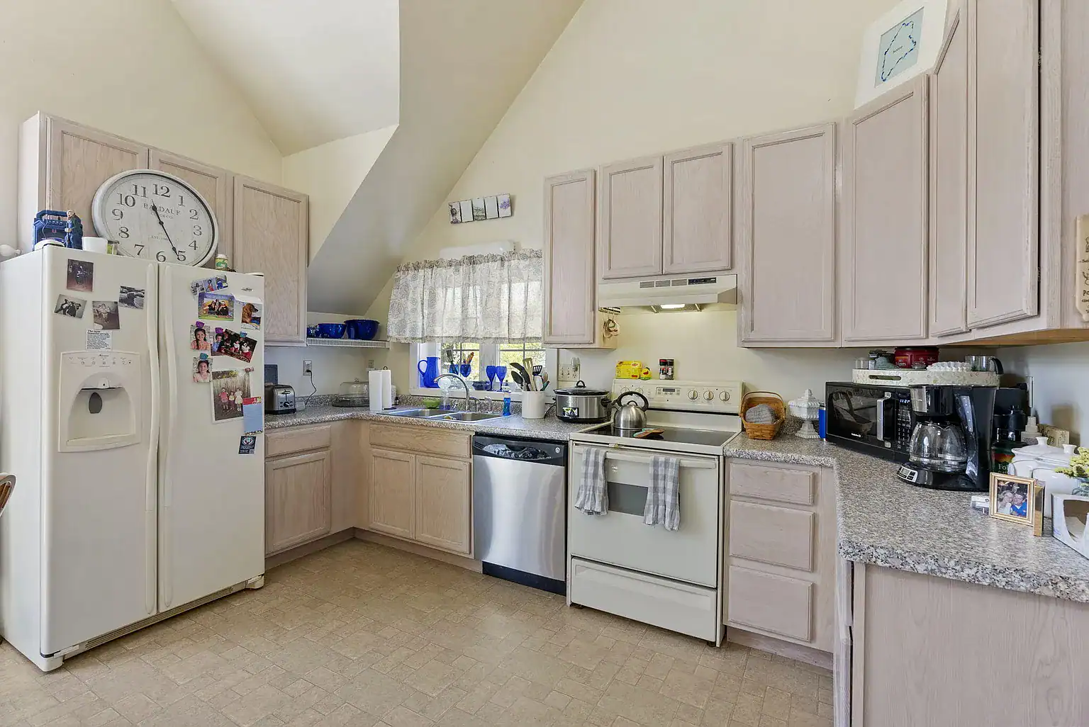 Bright residential kitchen with full-size appliances and dining space for clients at Southern Maine Recovery