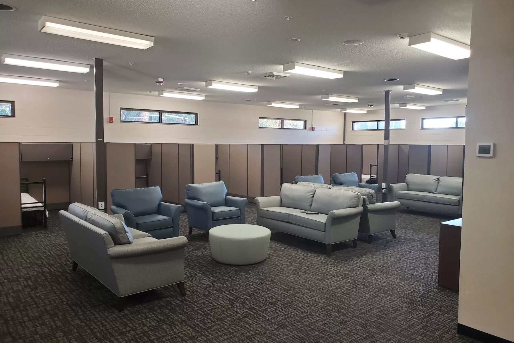 Community lounge with sofas, armchairs, and privacy dividers