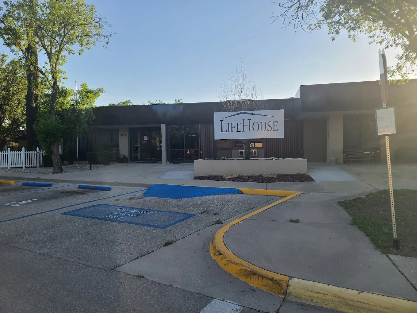 Large LifeHouse sign outside the facility building with flowers