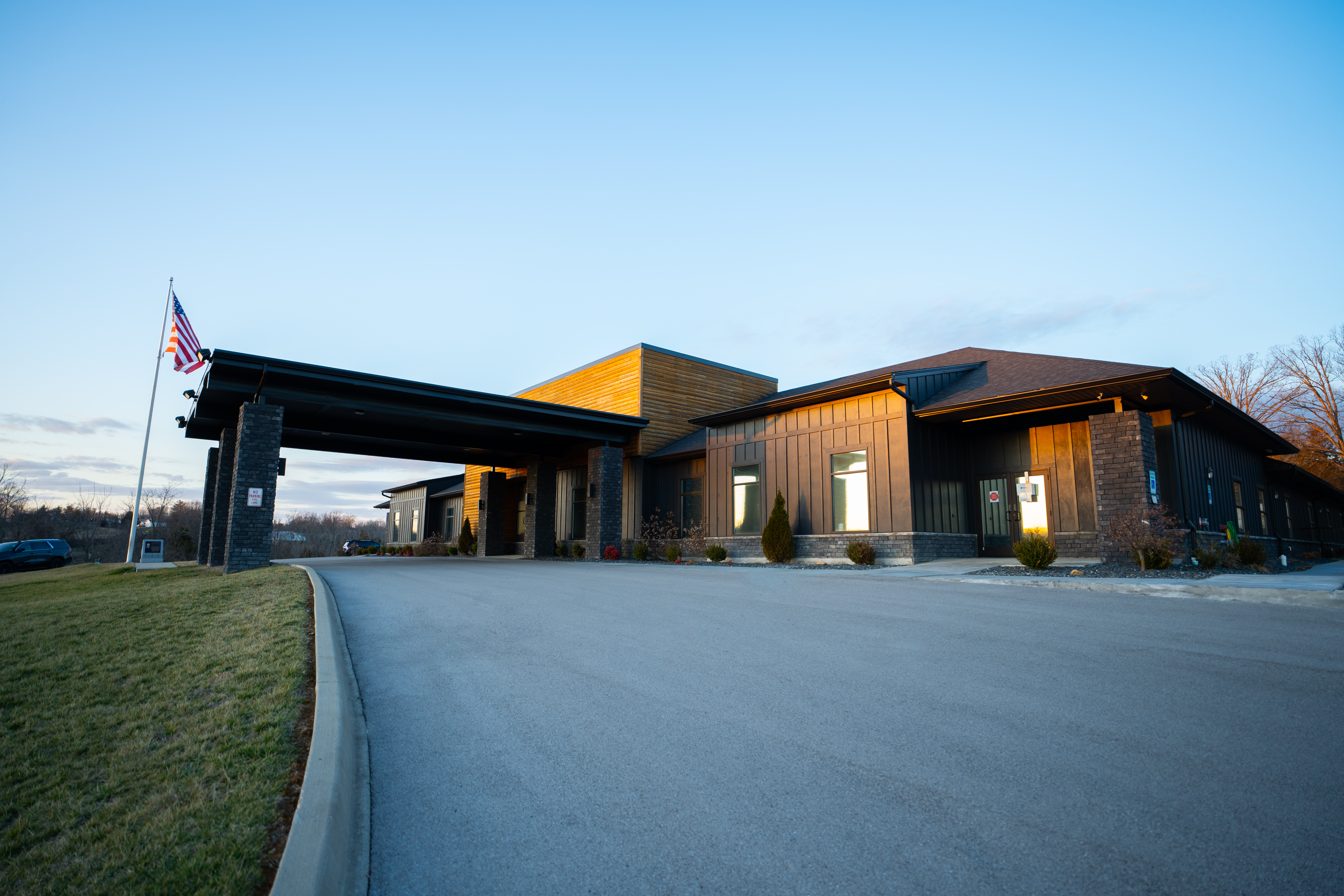 Rehab center exterior with flag and covered entrance