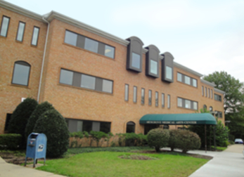 Brick medical office with green awning at main entrance