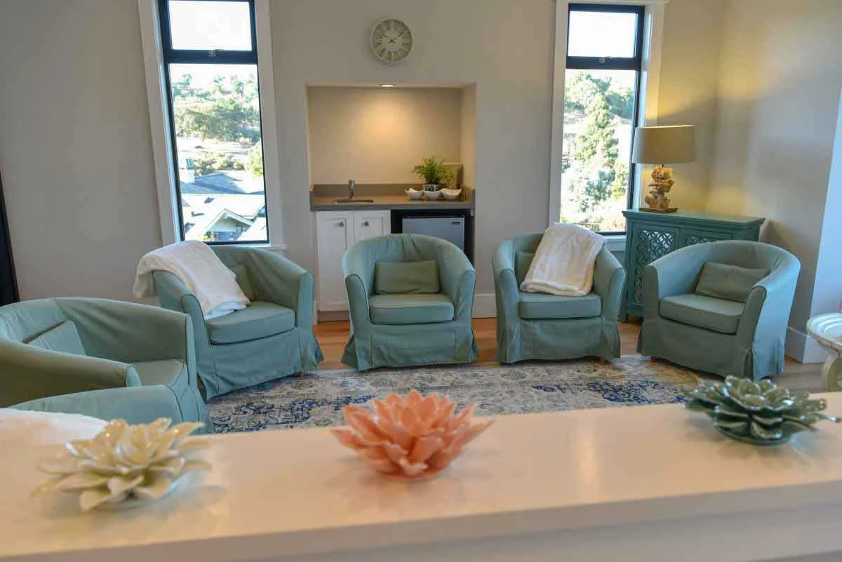 Circular chairs arranged around a small kitchenette