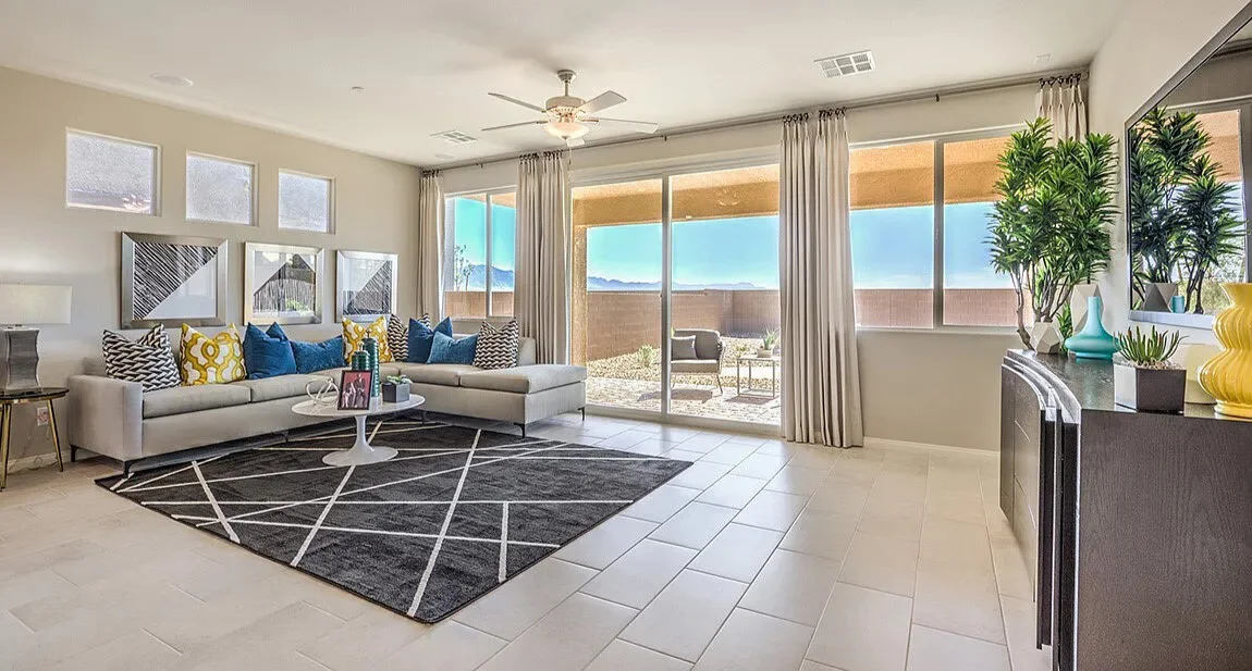 Bright living room with sectional sofa, large windows, patio access, and modern furnishings