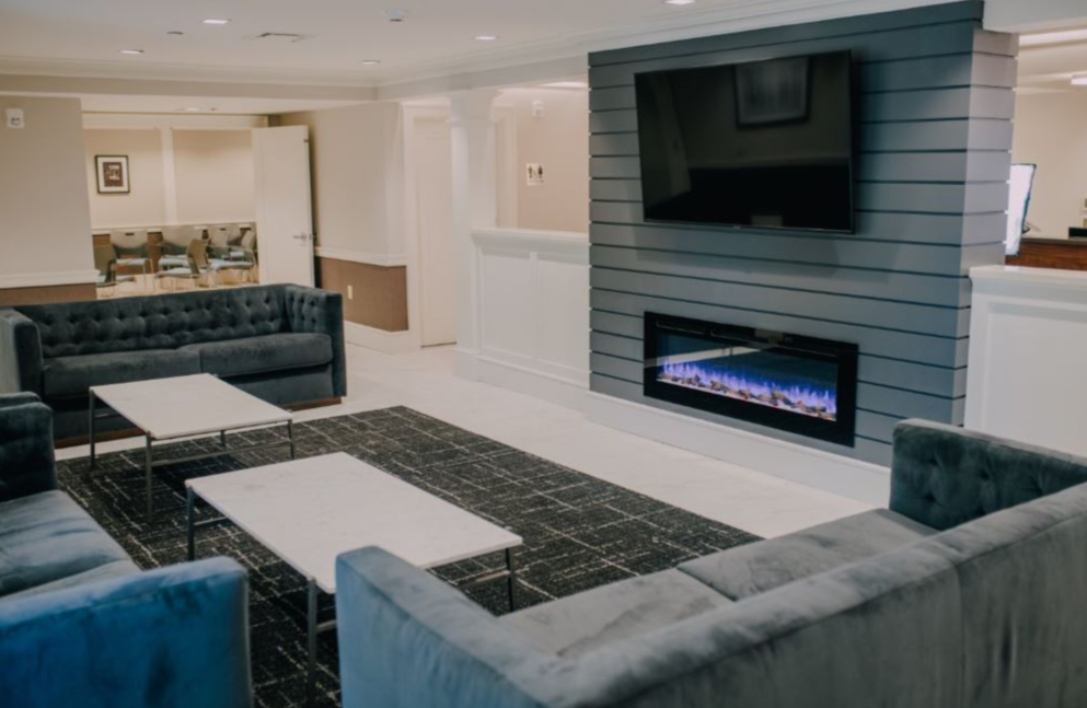 Comfortable lounge with sofas, TV, and fireplace