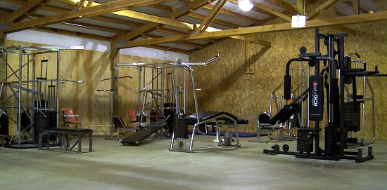 Workout machines in open-beam wooden gym