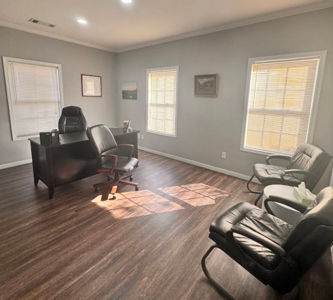 Counseling office with desk and guest seating