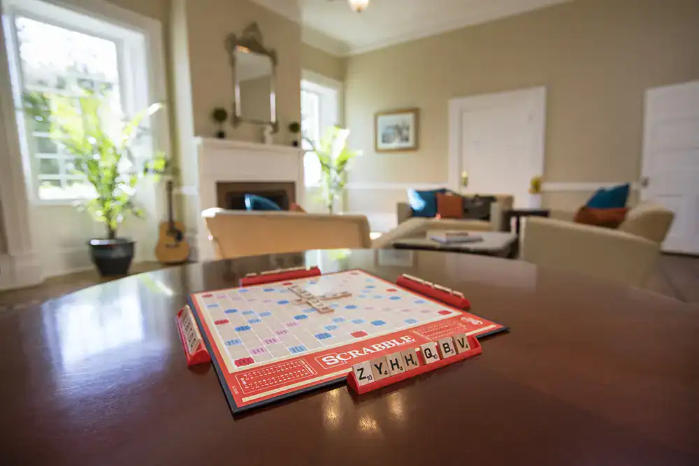 Scrabble board on table in cozy lounge with guitar