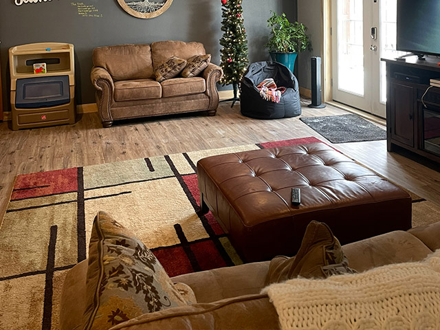 Warm lounge with couch, toys, and Christmas tree