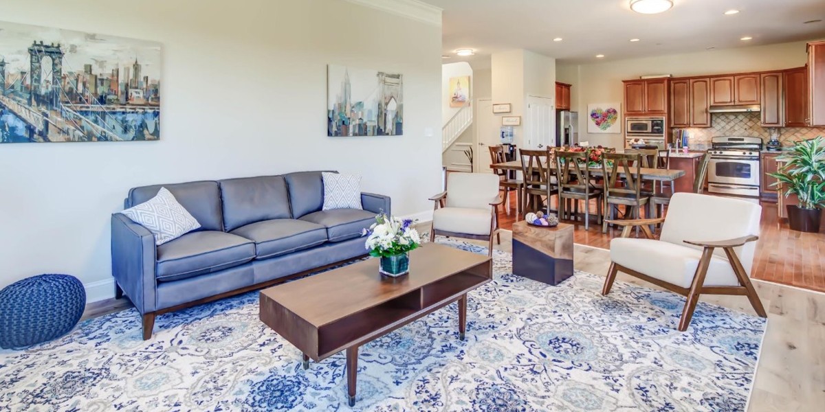 Modern open living area with sofa, dining table, and kitchen