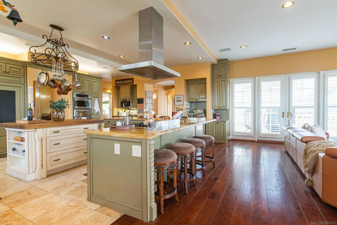 Spacious kitchen with island seating and large windows