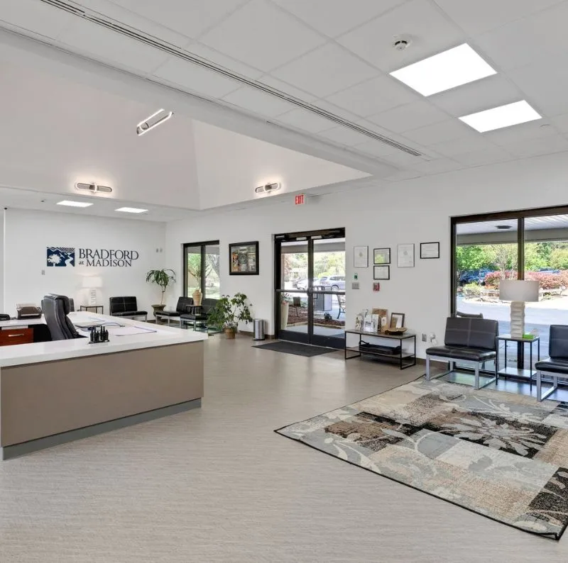 Reception desk and seating area with large front windows