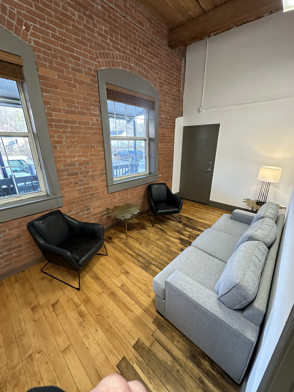 Small seating area with black chairs and a gray couch