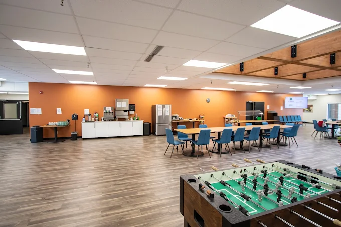 Foosball table and long dining setup in open space