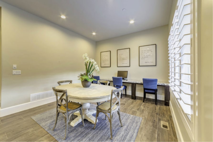 Round table and desks in a bright room with computers