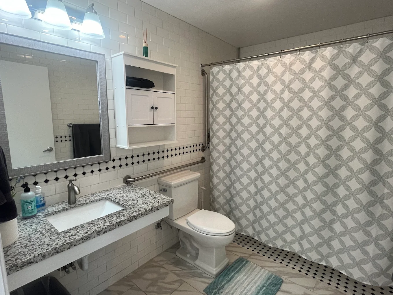 Clean bathroom with walk-in shower and sink