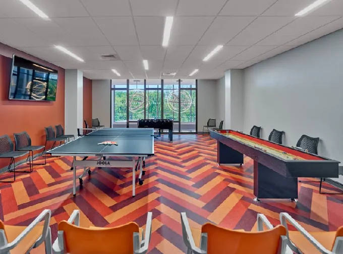 Game room with ping pong, shuffleboard, and foosball tables