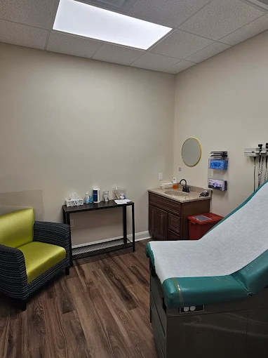 Counseling room with exam table and green chair