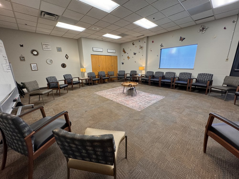 Circle of chairs with butterfly-themed wall