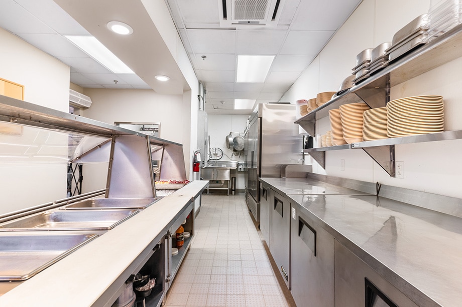 Commercial kitchen with serving counter and stainless appliances