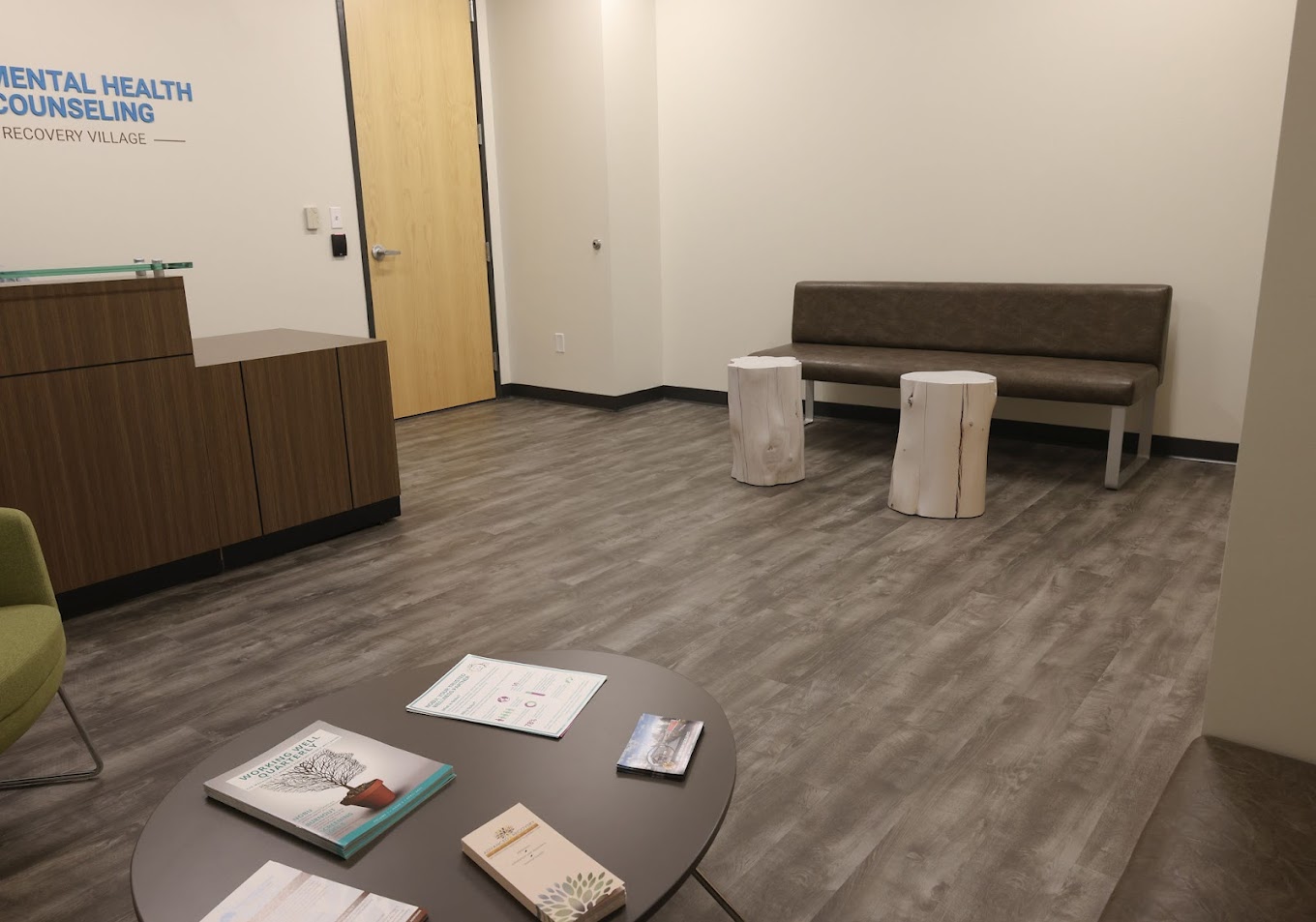 Reception area with a desk and seating in a rehab facility.