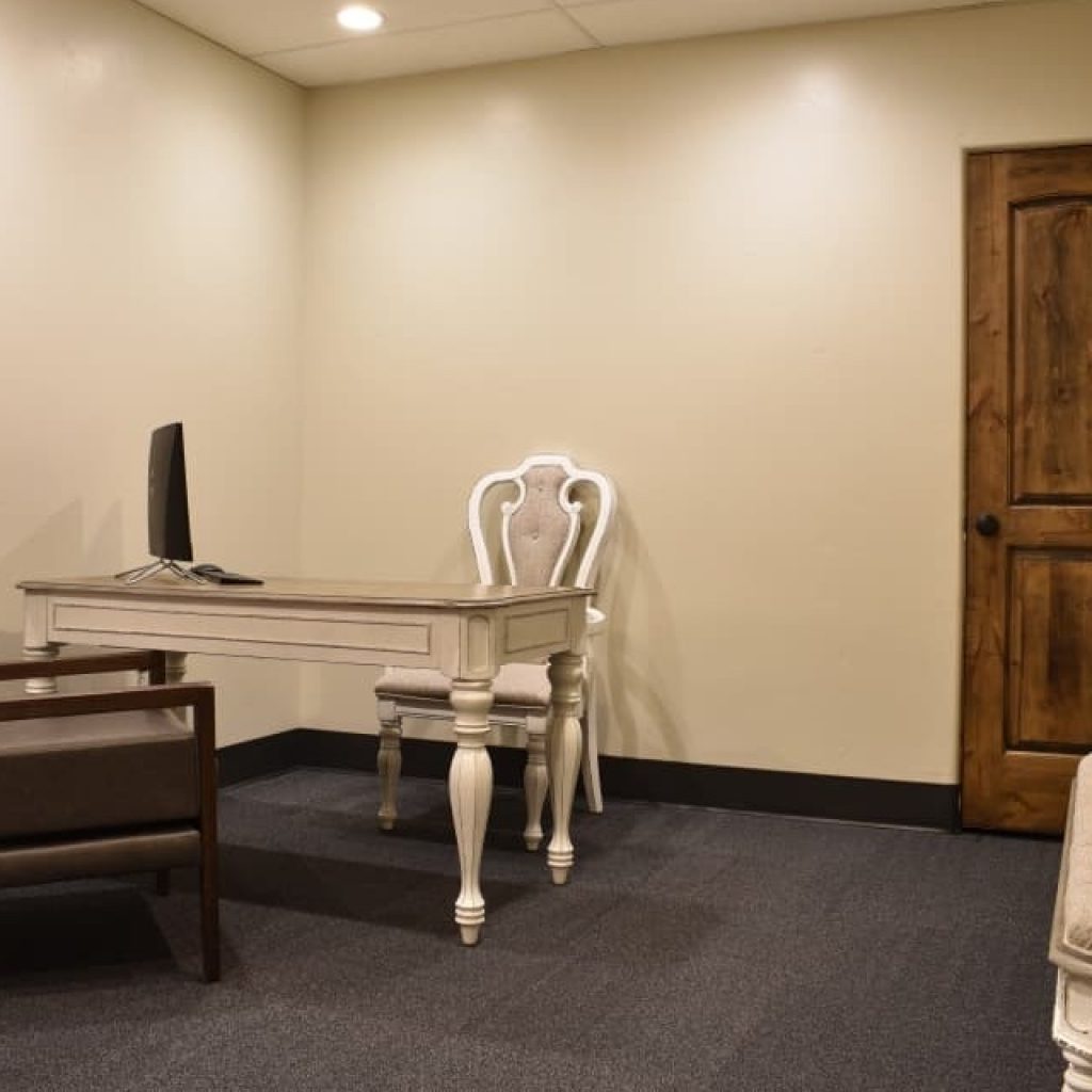 Desk with upholstered chair and computer setup