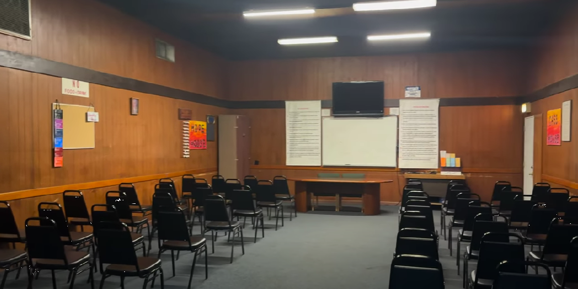 Classroom with black chairs and wood-paneled walls