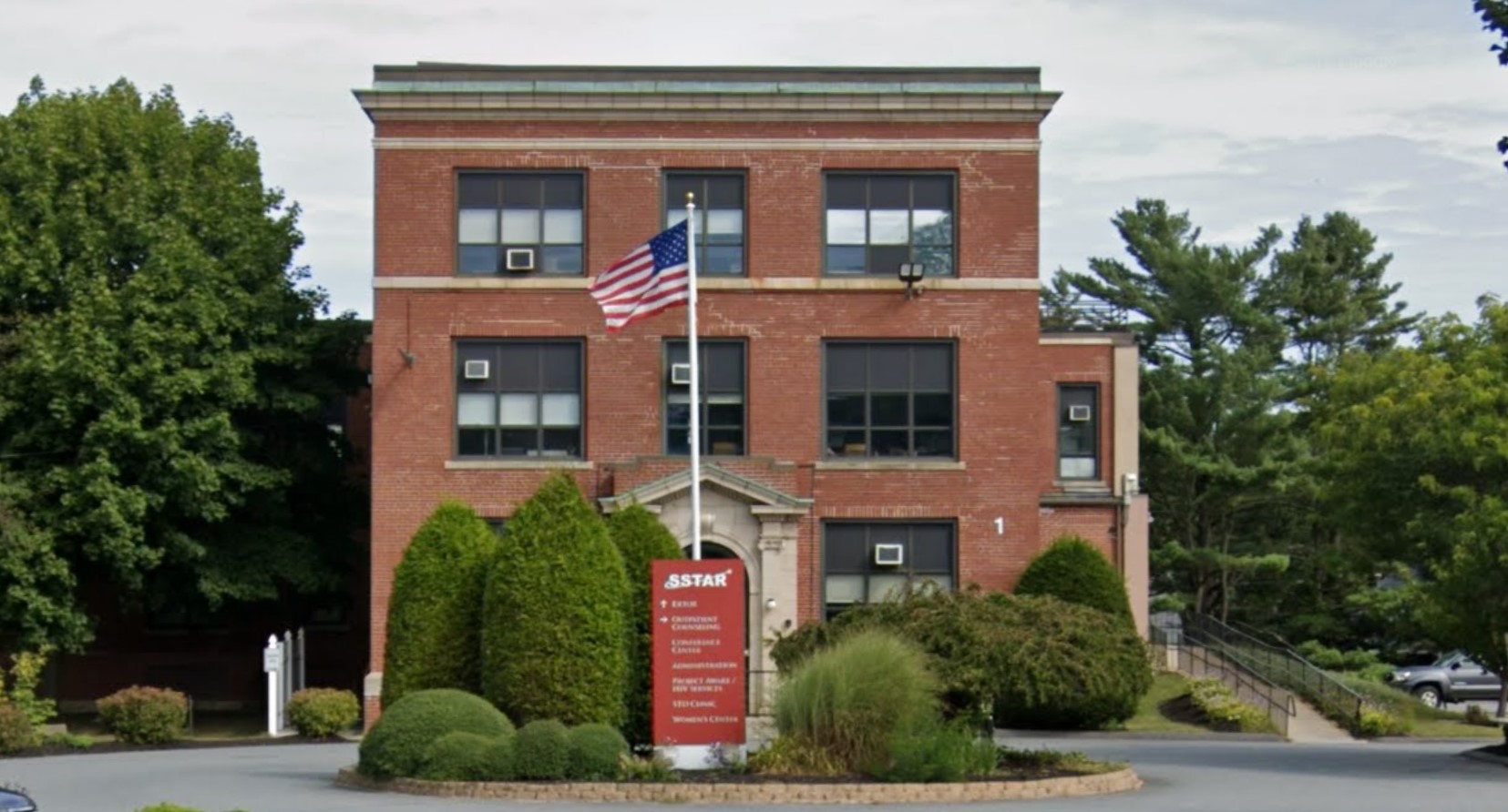 Exterior front view of the rehab facility with stairs to entrance.