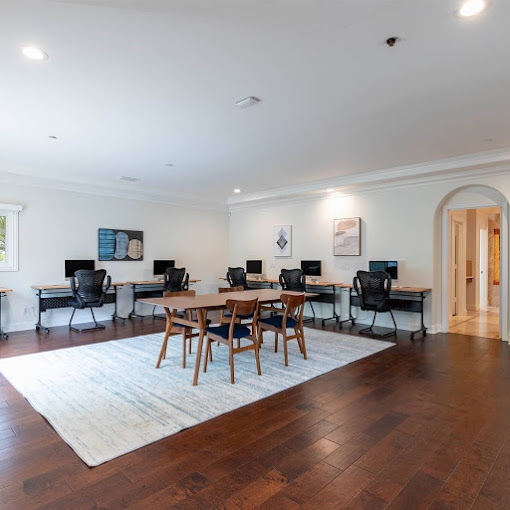 Study area with desks, chairs, and computers.