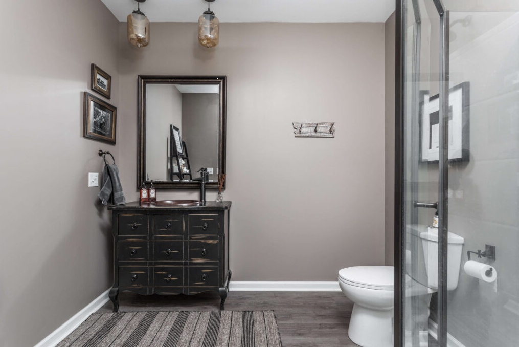 Bathroom with vanity, mirror, and walk-in shower