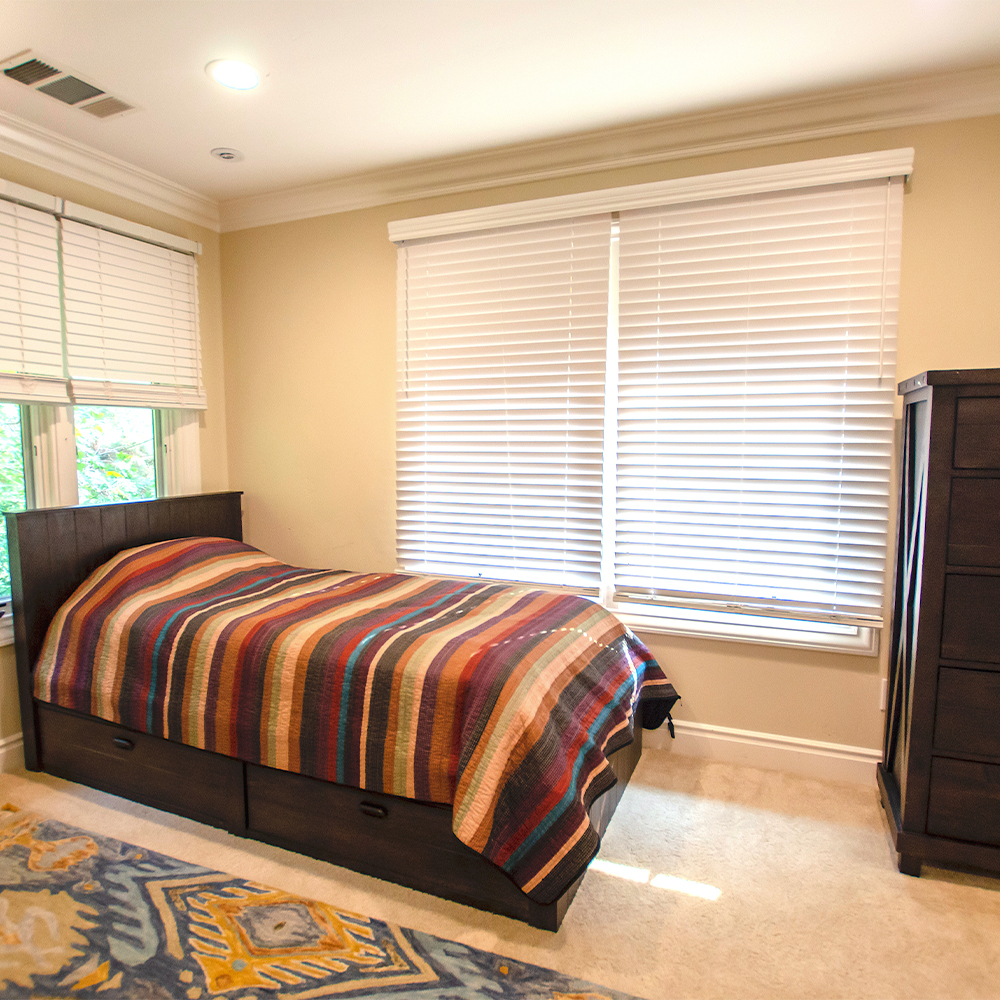 Private bedroom with bed and closet.