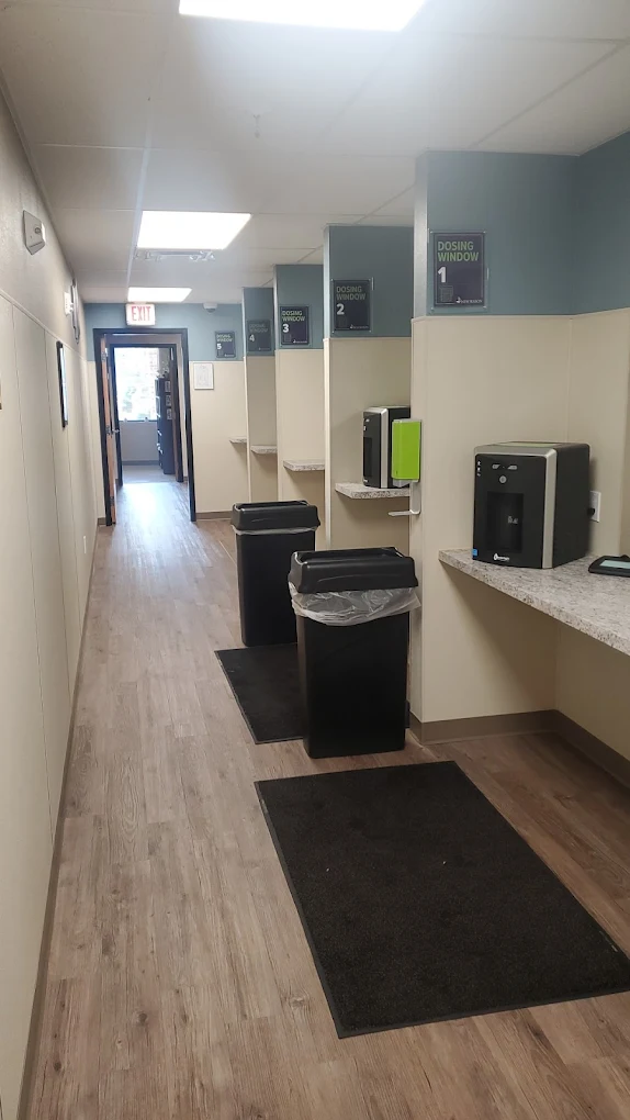 Hallway with private medication dosing windows and counters