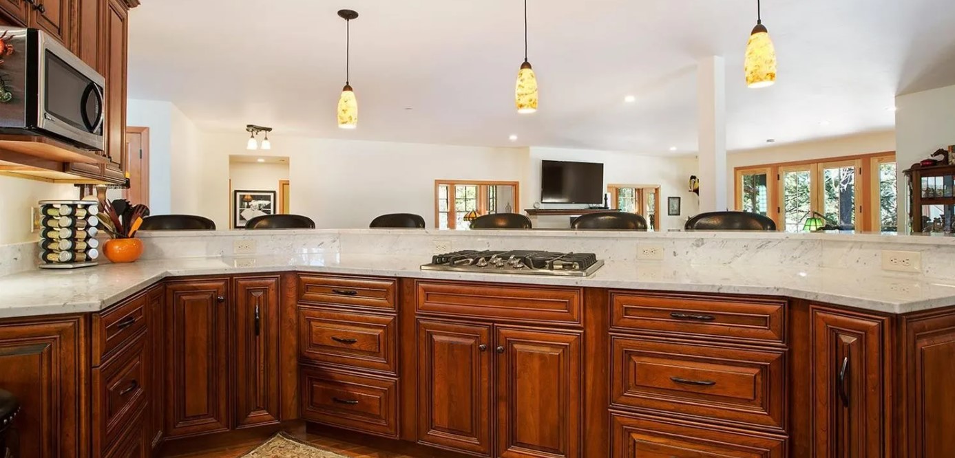 Kitchen with seats behind counter.