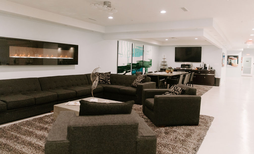 Common room with sectional sofa and fireplace