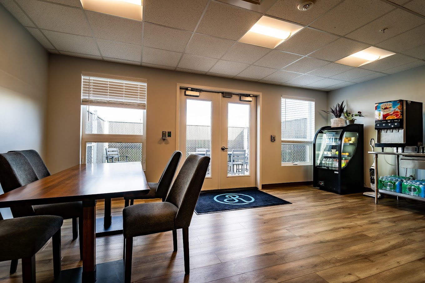 Dining space with table, chairs, beverage cooler, and snack station.