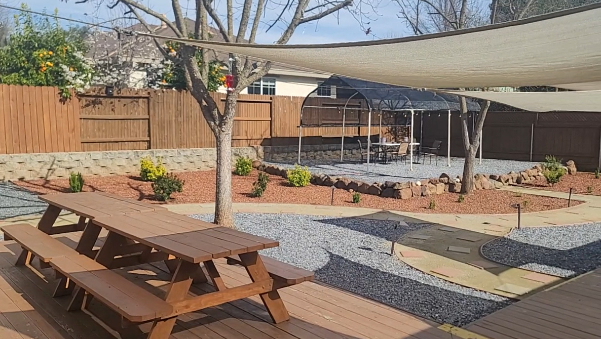 Patio gazebo with chairs in a landscaped rehab garden