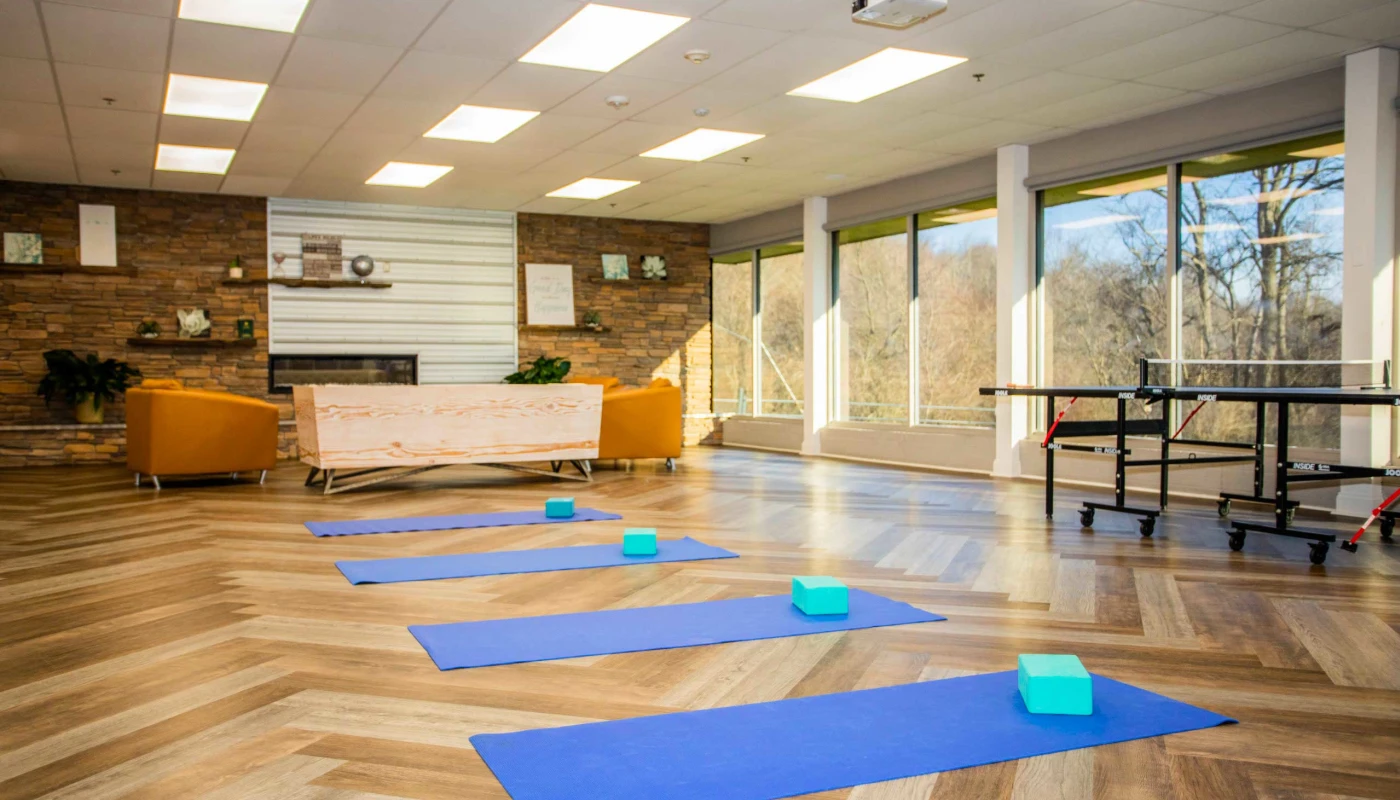 Yoga mats and blocks in sunny fitness room